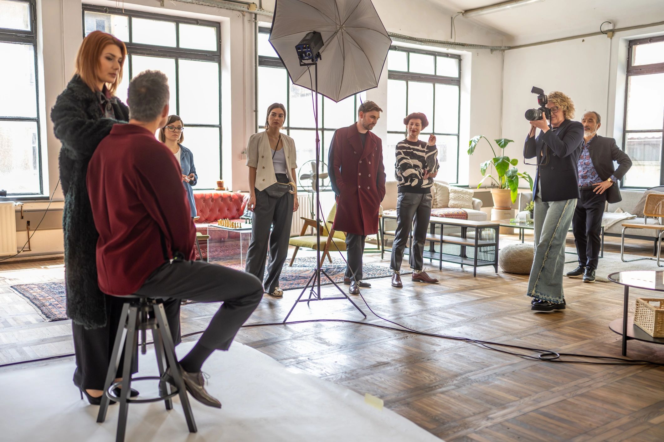 Production team preparing a studio set with lighting equipment
